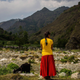 An unrelated woman tending to her goats in Nepal. Image via Getty.